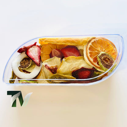 Assorted dried fruits in a crystal trapezoid container — elegant vegan snack mix for gifting.