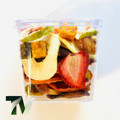 Crystal cup of natural dried fruits — apple, kiwi, orange, fig, peach, strawberry — healthy vegan gift idea.
