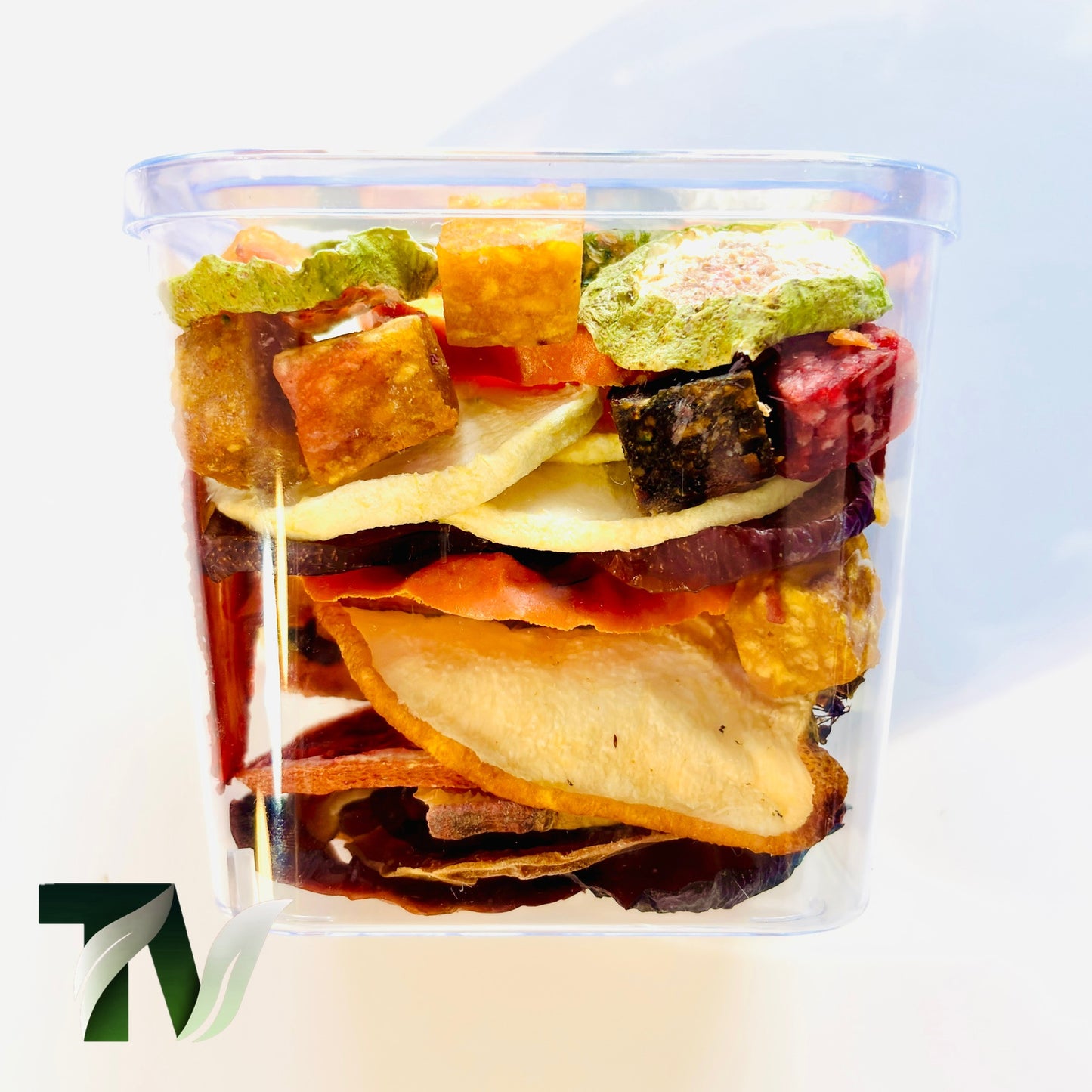 Crystal cup of natural dried fruits — apple, kiwi, orange, fig, peach, strawberry — healthy vegan gift idea.