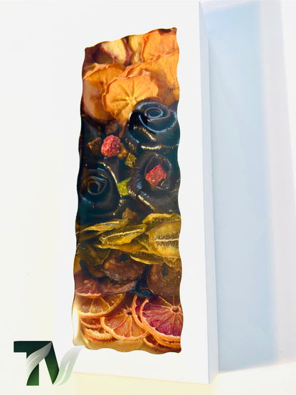 Natural gourmet gift box with rose-shaped Persian Lavashak fruit rolls surrounded by assorted dried fruits — kiwi, persimmon, citrus, and peach slices — handmade and vegan with no added sugar.