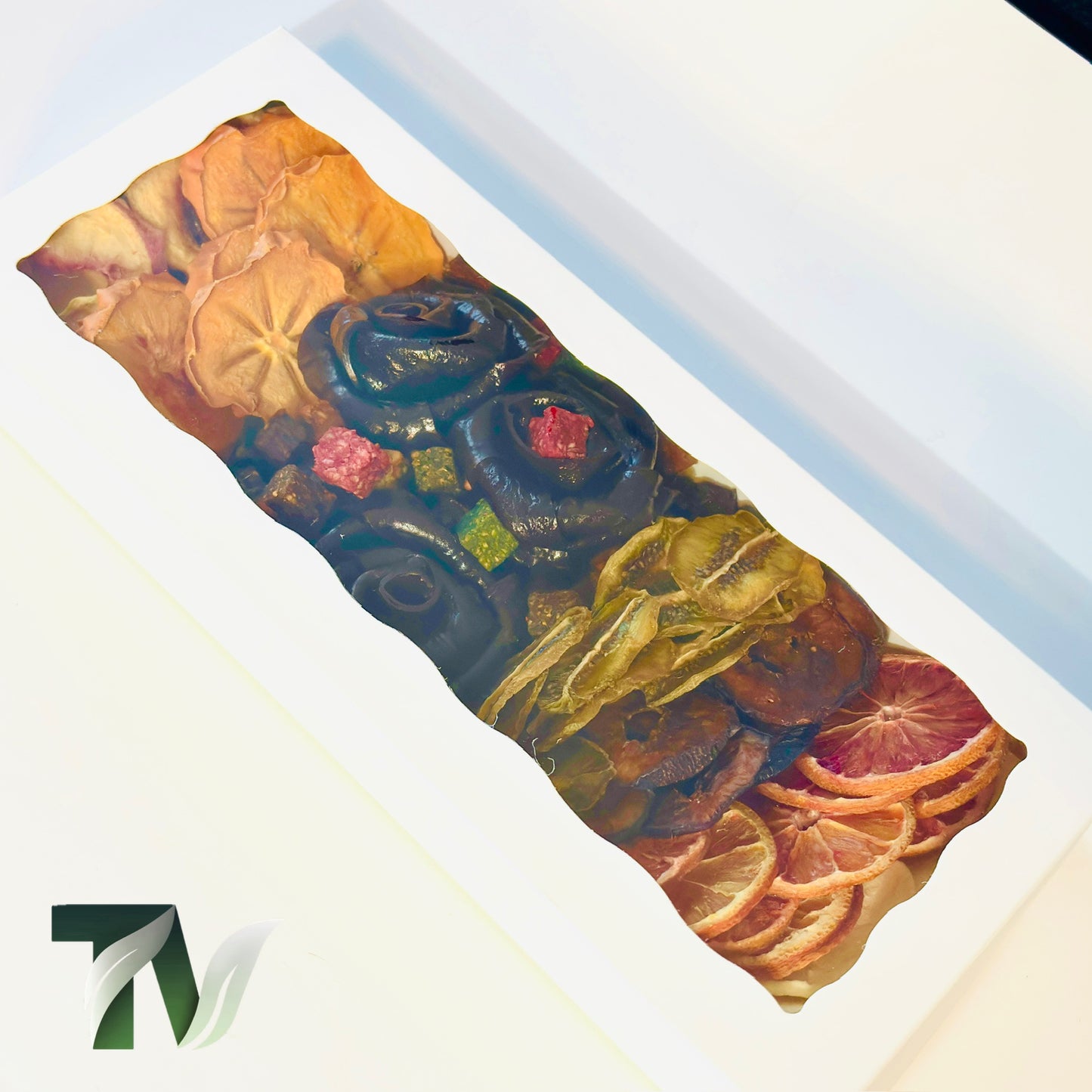 Natural gourmet gift box with rose-shaped Persian Lavashak fruit rolls surrounded by assorted dried fruits — kiwi, persimmon, citrus, and peach slices — handmade and vegan with no added sugar.