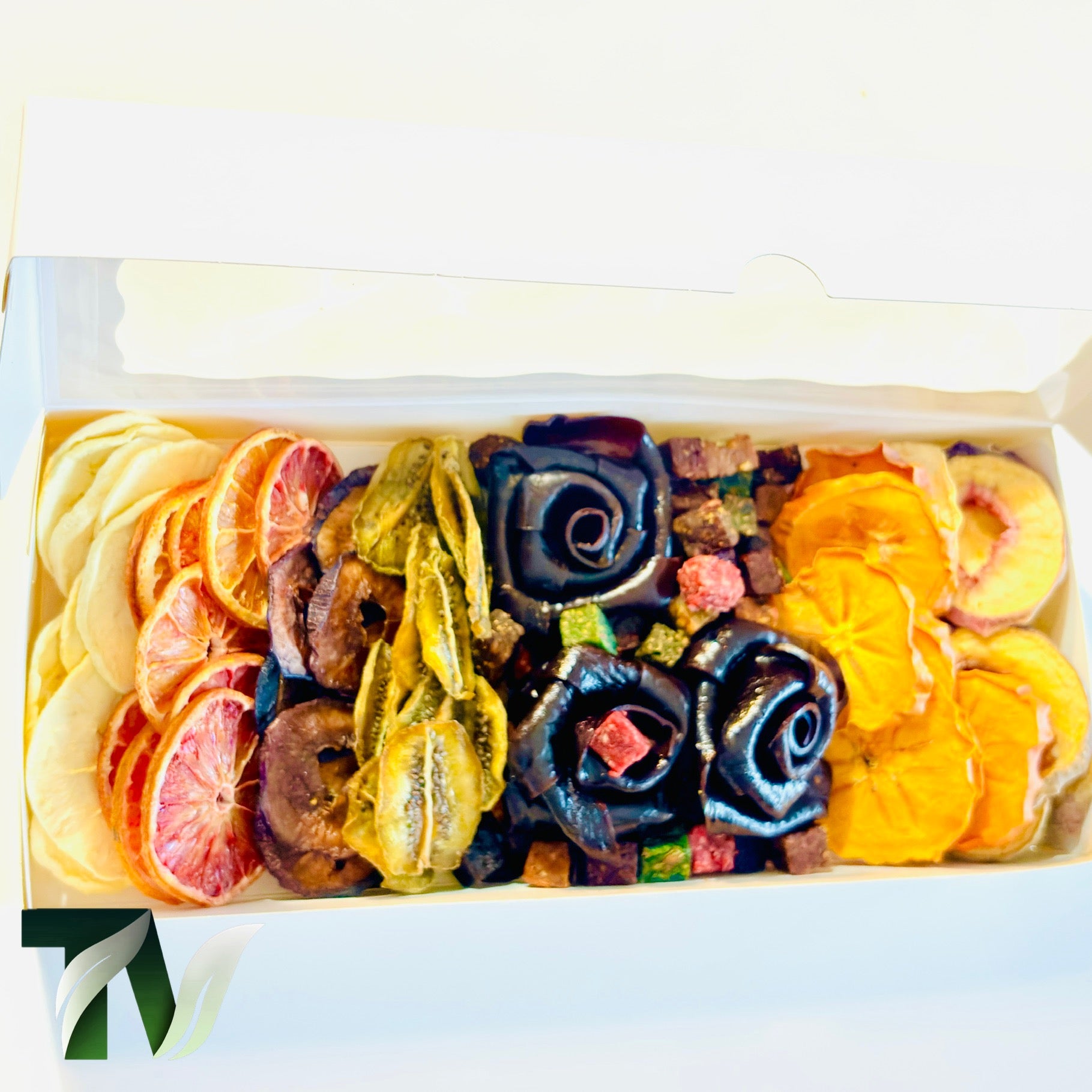 Beautifully arranged dried fruit and Lavashak rose box with mixed natural fruits including orange slices, banana, kiwi, and handcrafted fruit leather roses — perfect healthy vegan gift idea.