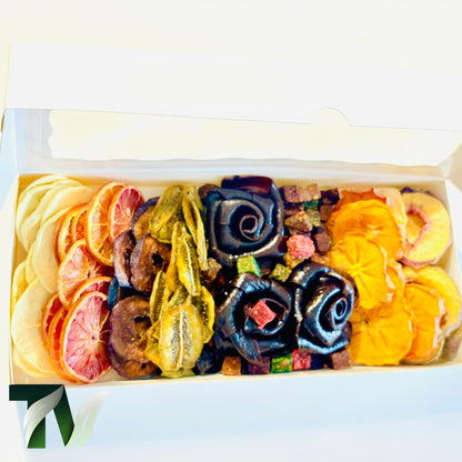 Beautifully arranged dried fruit and Lavashak rose box with mixed natural fruits including orange slices, banana, kiwi, and handcrafted fruit leather roses — perfect healthy vegan gift idea.